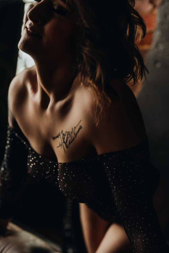 Ashley wearing rhinestone mesh lingerie, laughing mid-pose in her boudoir session