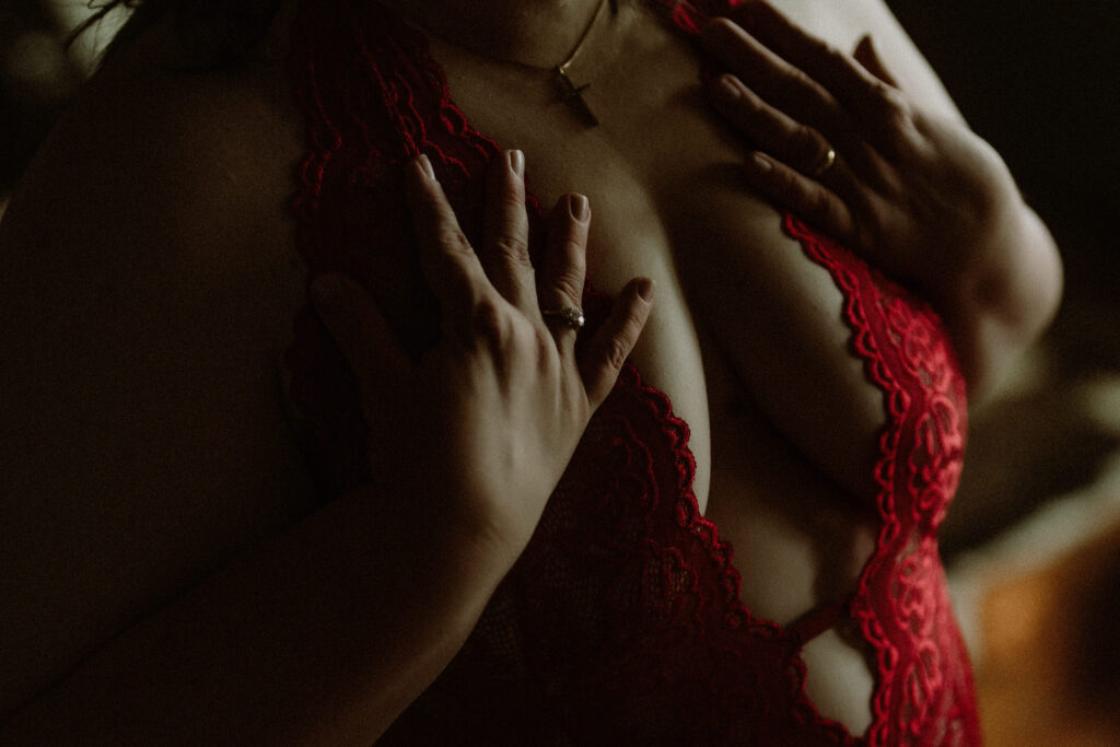 Close-up of anonymous client in red lace bodysuit, featured in her boudoir experience story at Elevation Boudoir in Tuscaloosa, Alabama