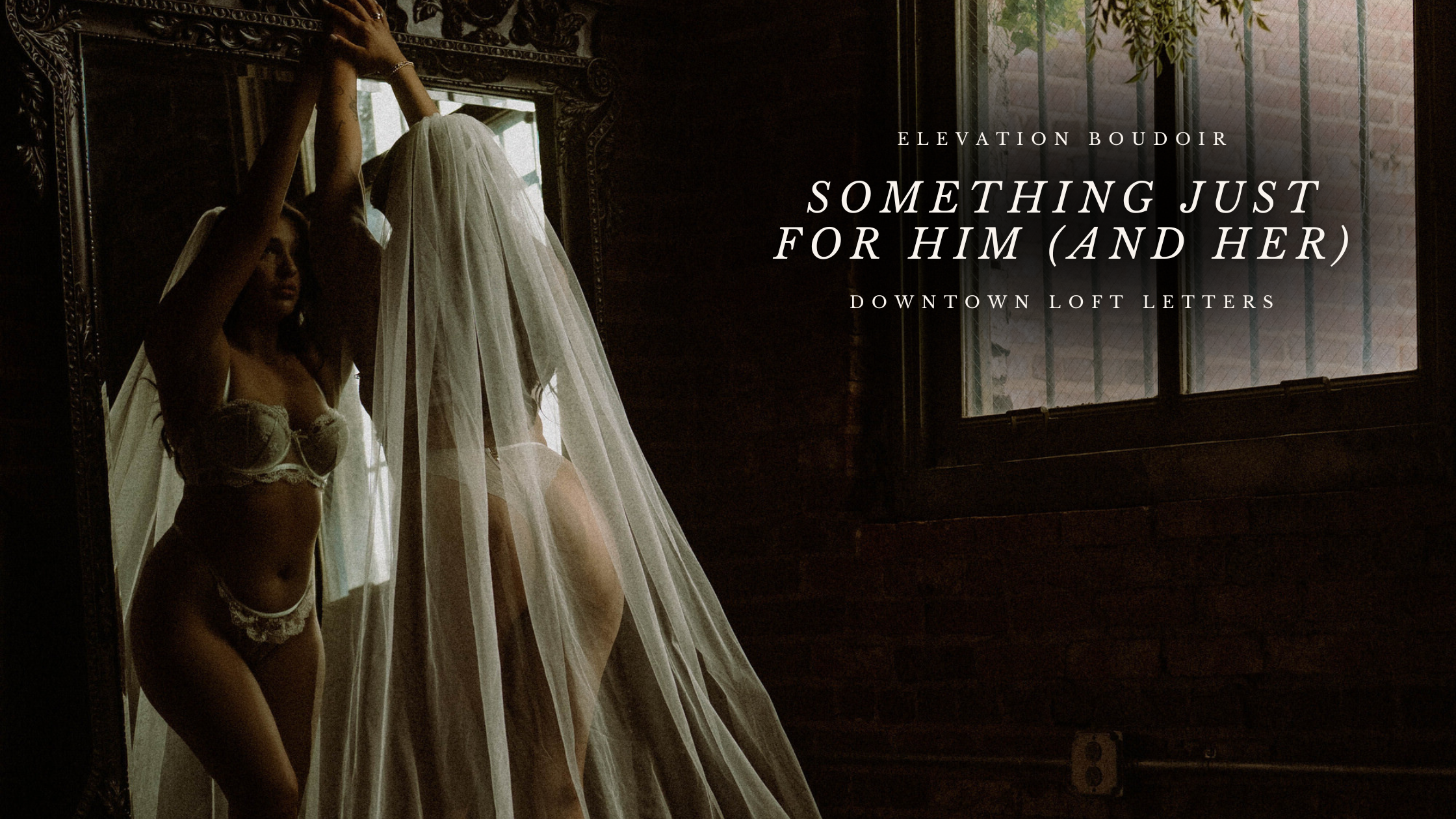 Bride in lace lingerie and cathedral veil standing in front of ornate mirror at Elevation Boudoir, with text overlay reading “Something Just for Him (and Her) – Downtown Loft Letters”