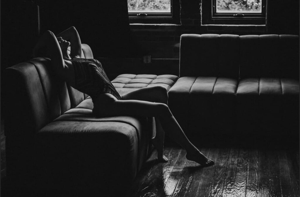 black and white image of a boudoir pose to show of the long legs