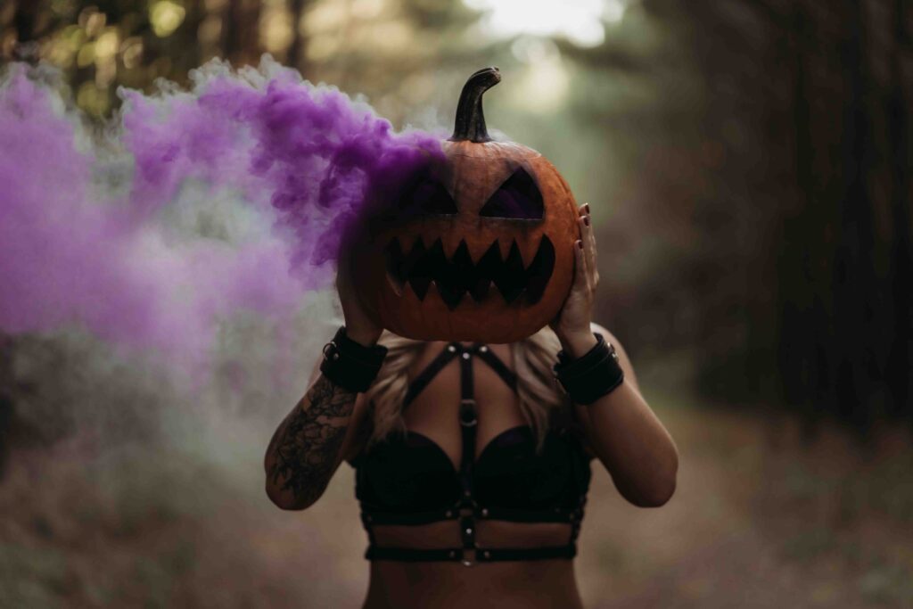 Client holding pumpkin with purple smoke