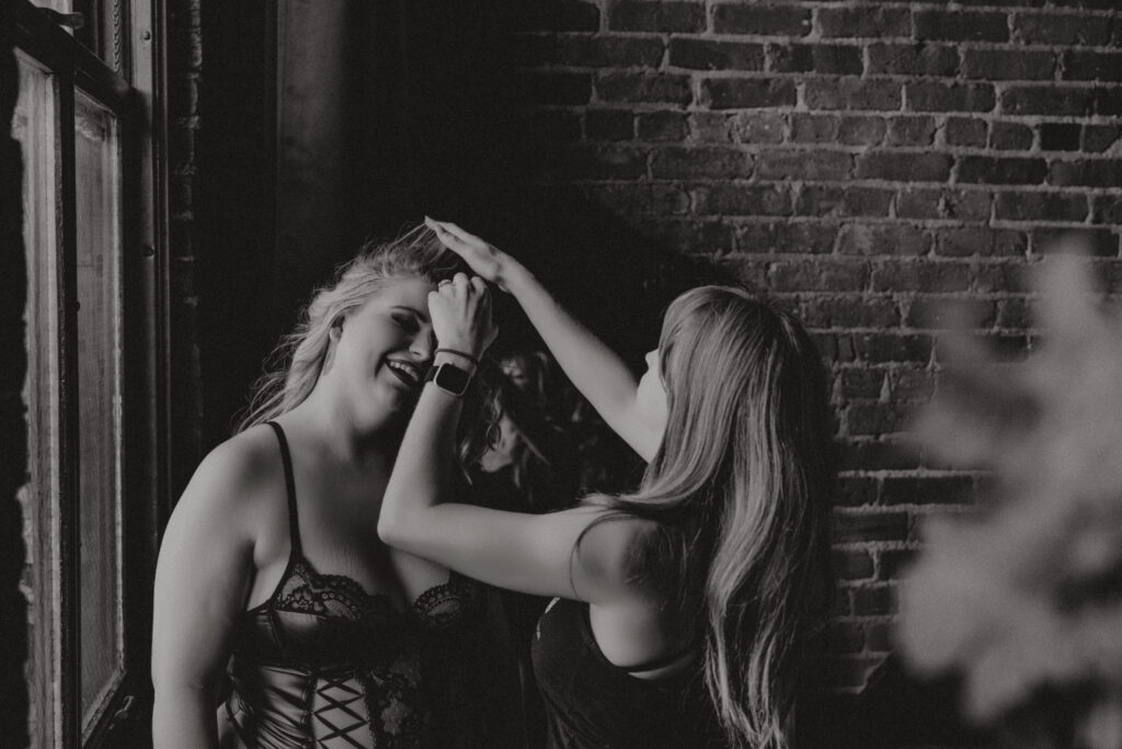 Behind the scenes at Elevation Boudoir—Rachel adjusting hair for her transformation